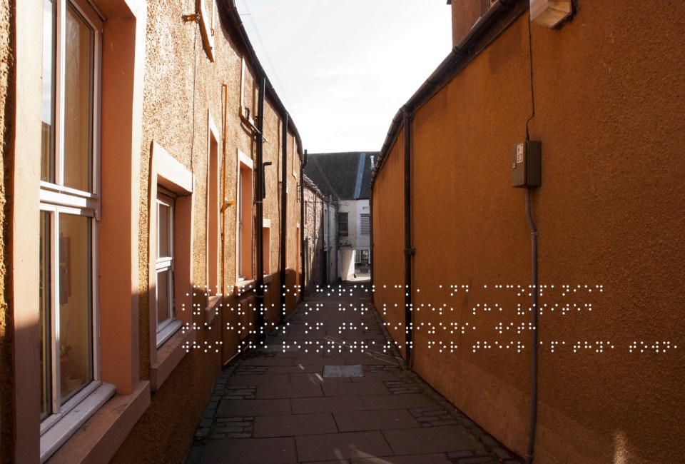 Orange walls of a close. Quote taken from historical figure shown in Braille